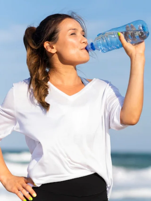 woman-staying-hydrated-beach-while-working-out_23-2148694896